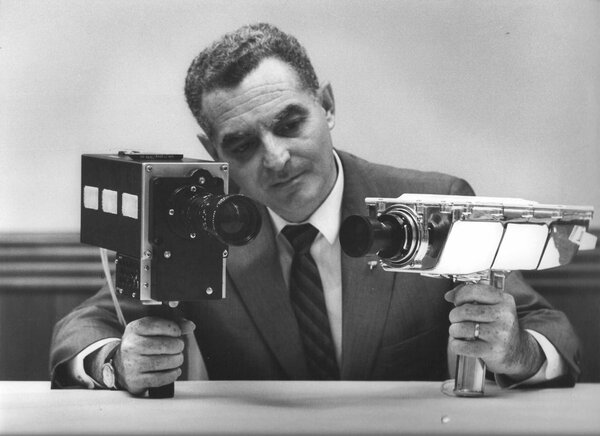 Stan Lebar from Westinghouse holding the TV color camera with Angenieux 6x25 zoom used for the Apollo 11 mission in his right hand.