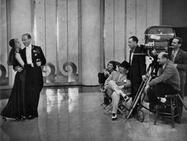 Shooting “Shall We Dance” in 1937 - From left to right: Ginger Rogers and Fred Astaire, director Mark Sandrich (seated), cinematographer David Abel (standing in a dark suit) and Joseph Biroc behind the camera