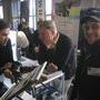 Sébastien Devaud, à d., sur le stand Emit ; au 2e plan, Jacques Delacoux (Transvideo) et Andrew Steele (Emit) - Photo Vincent Jeannot - (...) 