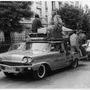 Bernard Château behind a 1958 Mercury's wheel, towing a 1963 Chevrolet Corvette, in 1966 - Bernard Château Collection 