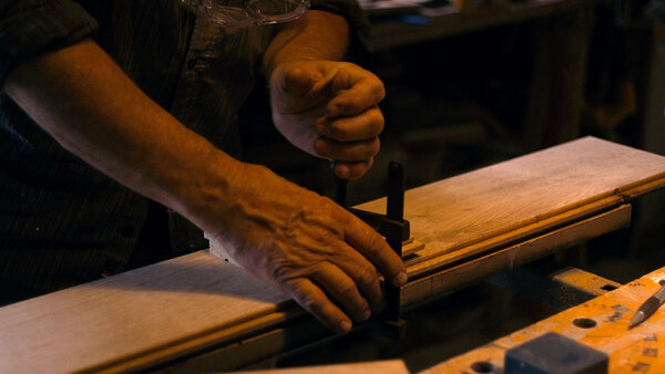 One of Bruno Nuytten's gestures while laying floorboards in his home - Screenshot from <i>Nuytten/Film</i>