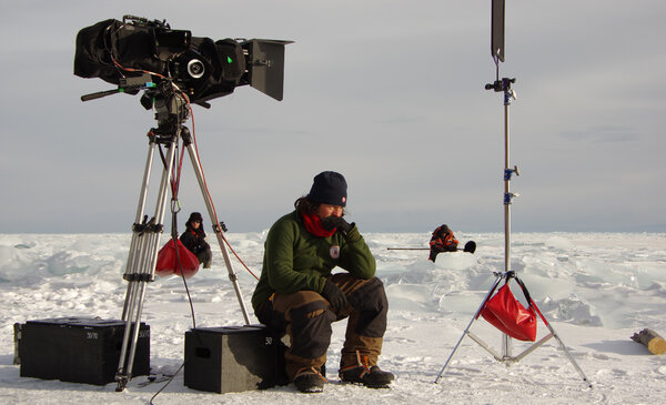 Hours of Equivalence - Benjamin, key grip, is sat on a weight while Franck, boom operator, and I, are waiting. Maybe that's what the new collective agreement refers to as Hours of Equivalence. <i>(Photo by Cyril Girard, gaffer, Wednesday 4 March)</i>