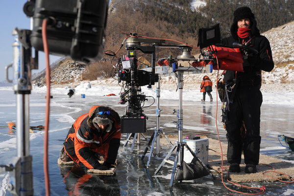 Ice skates - Jean-Christophe, prop master, who we also call "JC", walks on the water with skates cut in a carpet! Beside him, Benjamin Vial also assures the framing of this tracking shot set upon a meter of ice, on a horizontal ladder! We had made the choice to travel without any track… Between them, Timothy, 2<sup class="typo_exposants">nd</sup> AC, goes and get the B camera, immobilized on the lake. <i>(Gilles Porte, Saturday 21 February)</i>