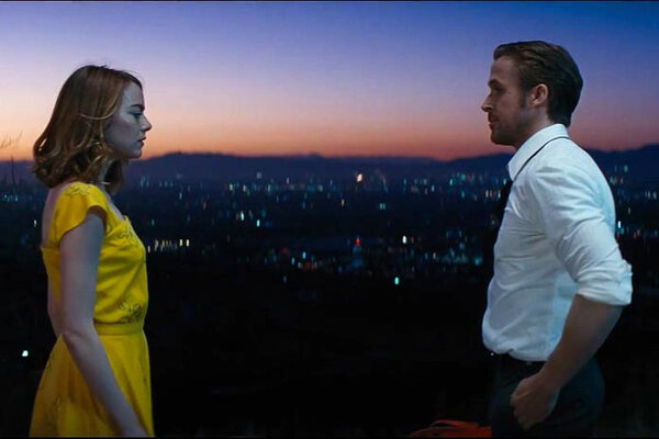 Emma Stone and Ryan Gosling with Hollywood in the background at sunset