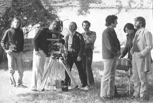 On the set of "Paulina 1880" - From L to R: Romain Winding, Andréas Winding (cinematographer), Jean Harnois (camera operator) and director Jean-Louis Bertucelli, in profile, engaged in discussion with an actor in costume