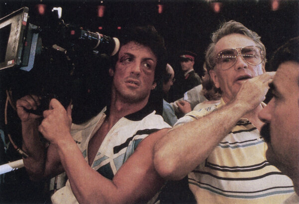 Sylvester Stallone and Bill Butler on the set of "Rocky IV" in 1986 - <i>American Cinematographer</i>, February 1986