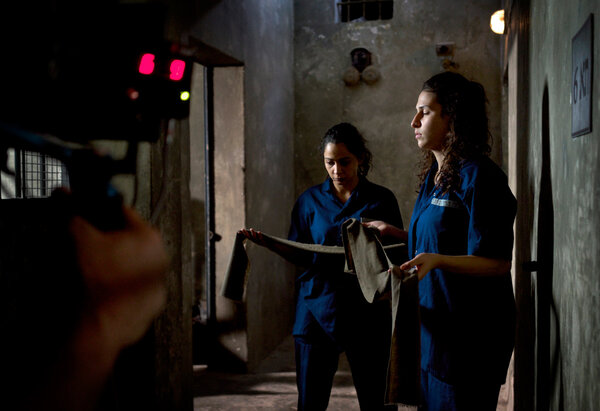 Zarqa. Maisa and Hana before the clap - Maisa et Hana deep in concentration, just a few seconds before the clap. At the other end of the hallway smoke machines, a dozen soldiers armed with batons and about twenty over excited female prisoner extras are waiting for them for a riot scene. We've been setting this scene up for three hours, Hana will close the scene in tears. <i>(Samuel, July Wednesday 16)</i>