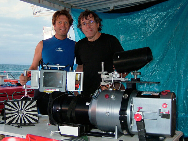 Philippe Ros, on the right, and René Heuzey, underwater cameraman, in front of the underwater shooting equipment - Housing and remote focus and aperture control (Transvidéo, HD Systems, Subspace). On location of <i>Oceans</i> in New Caledonia.